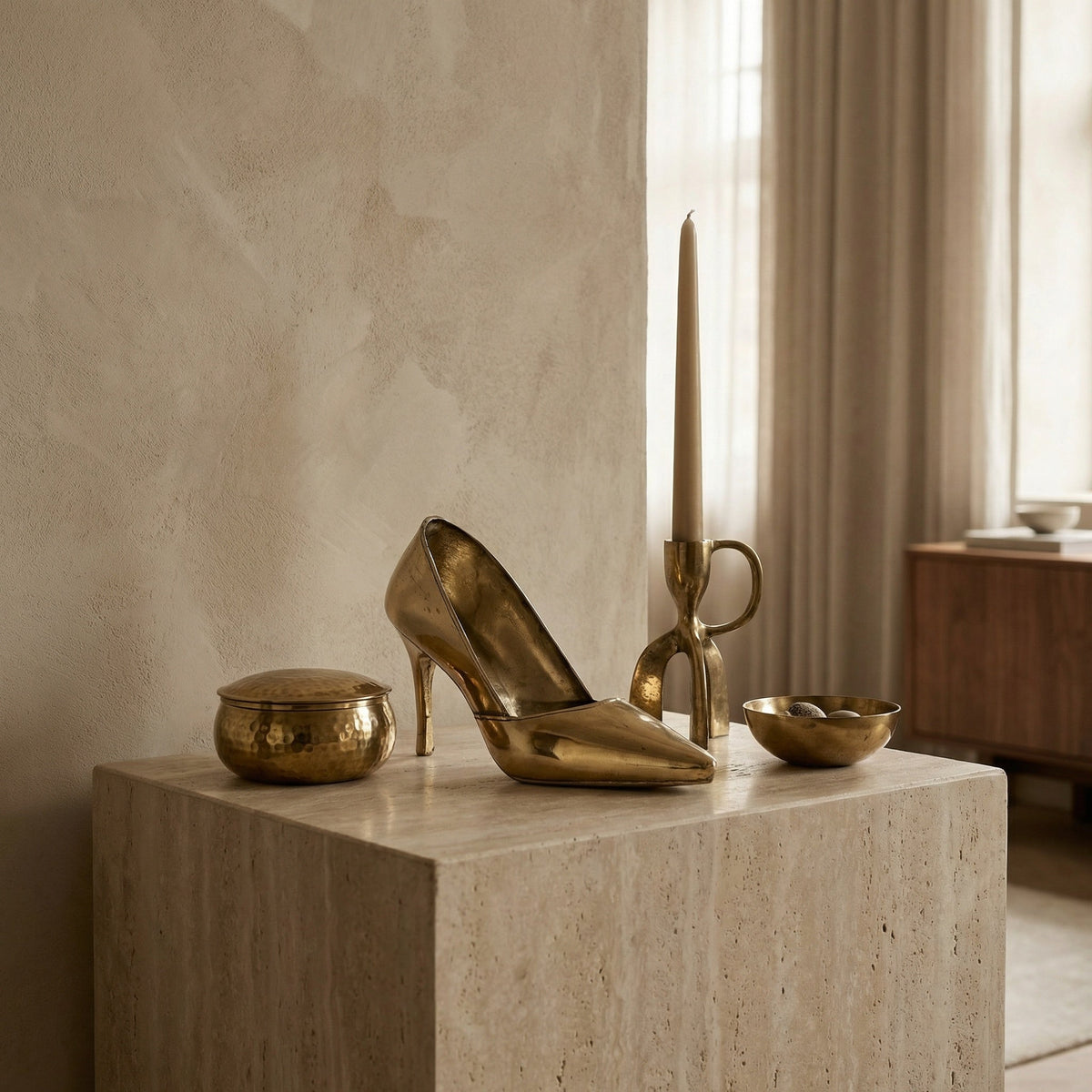 Noir Heel Sculpture Antique Brass styled in an interior setting