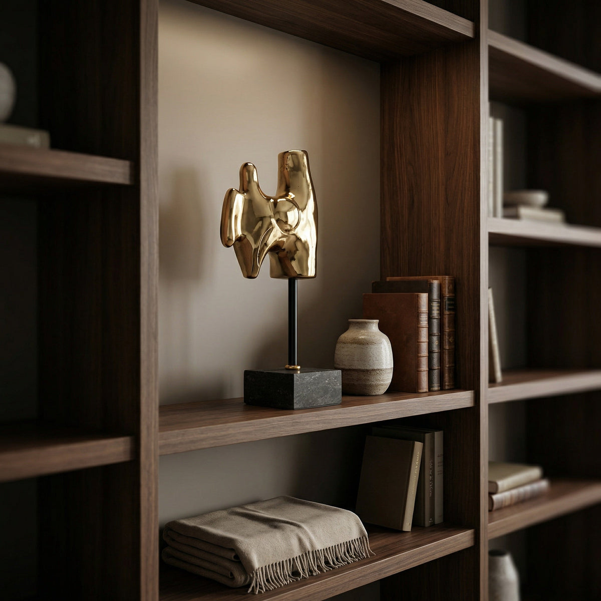 Noir Goker with Stand Sculpture Antique Brass styled in an interior setting