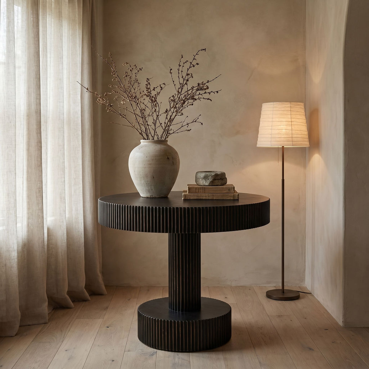 Noir Stringata Table Hand Rubbed Black with Light Brown Trim styled in an interior setting