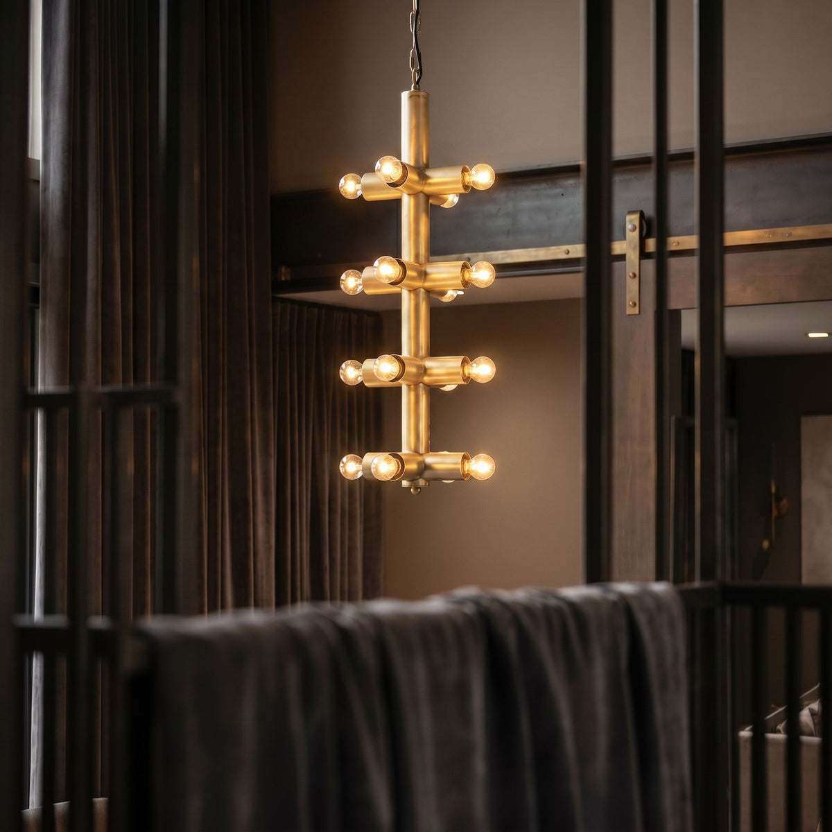 Noir Axe Chandelier Antique Brass styled in an interior setting