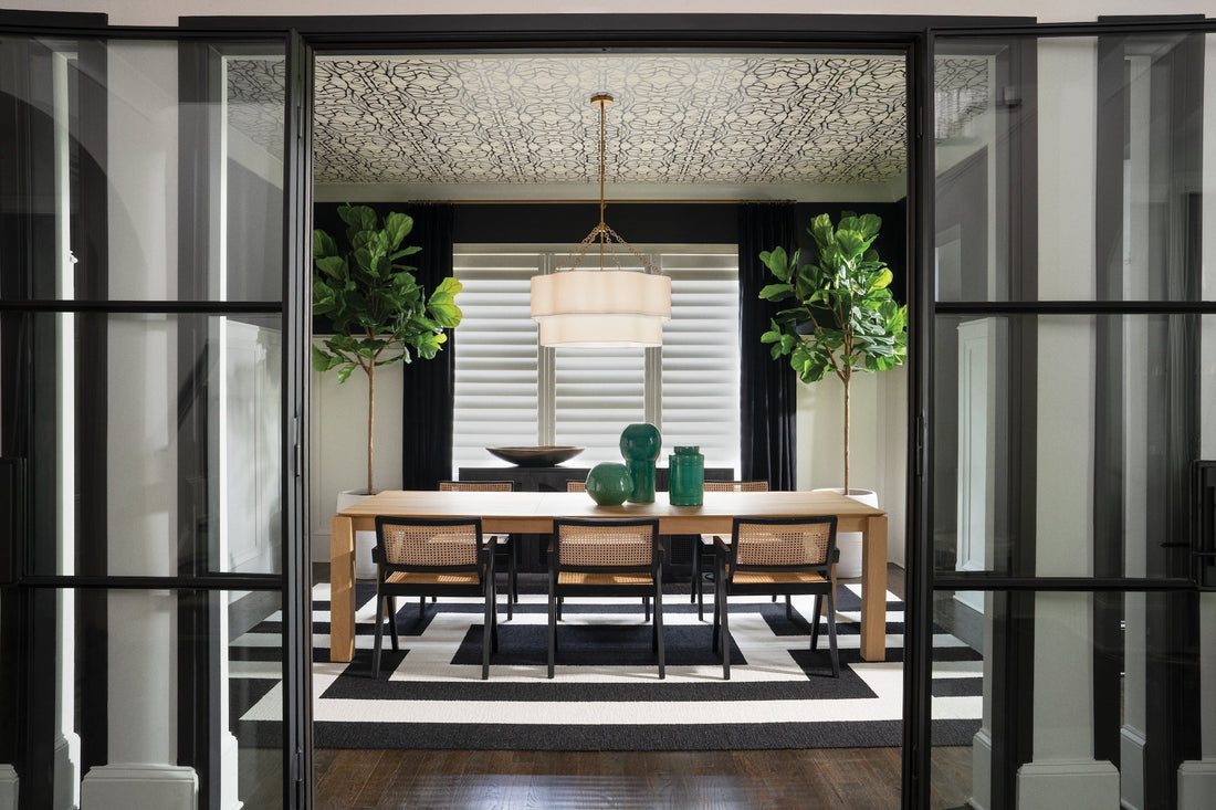 Brass drum chandelier with white linen shade in modern black and white dining room