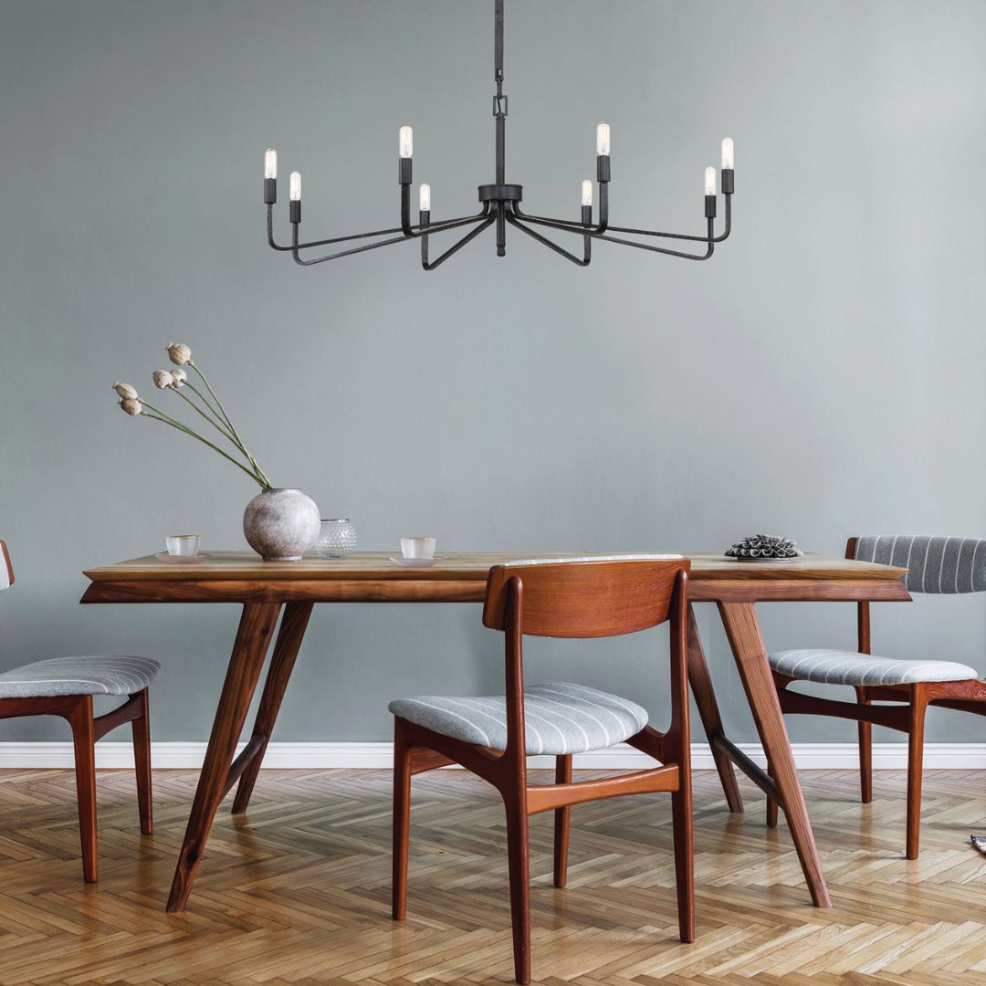 Salem 8-Light Chandelier styled in the center of a modern wooden dining chair with three side chairs around the table.