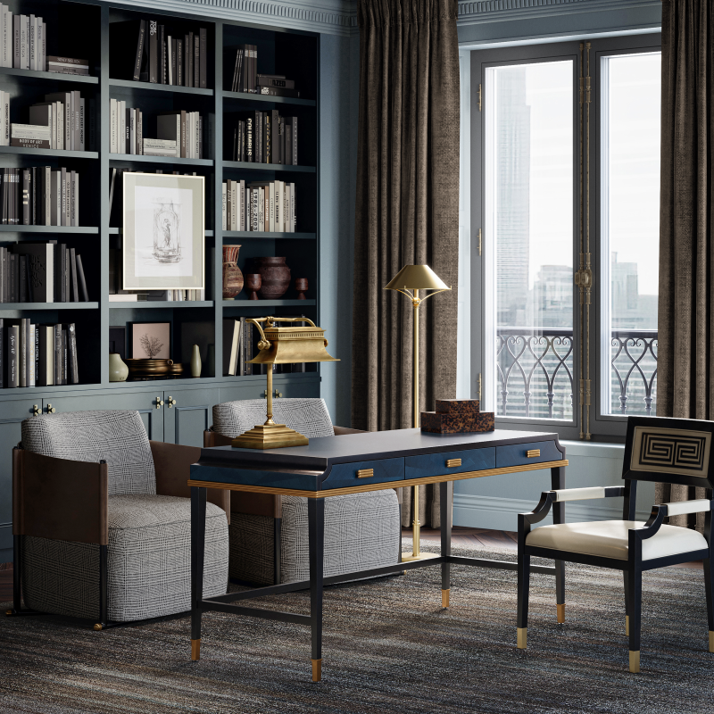 Kallista Large Blue Desk styled in a grand home office, paired with two accent chairs, a wall of shelves filled with books, brass table and floor lamps, and a coordinating desk chair.