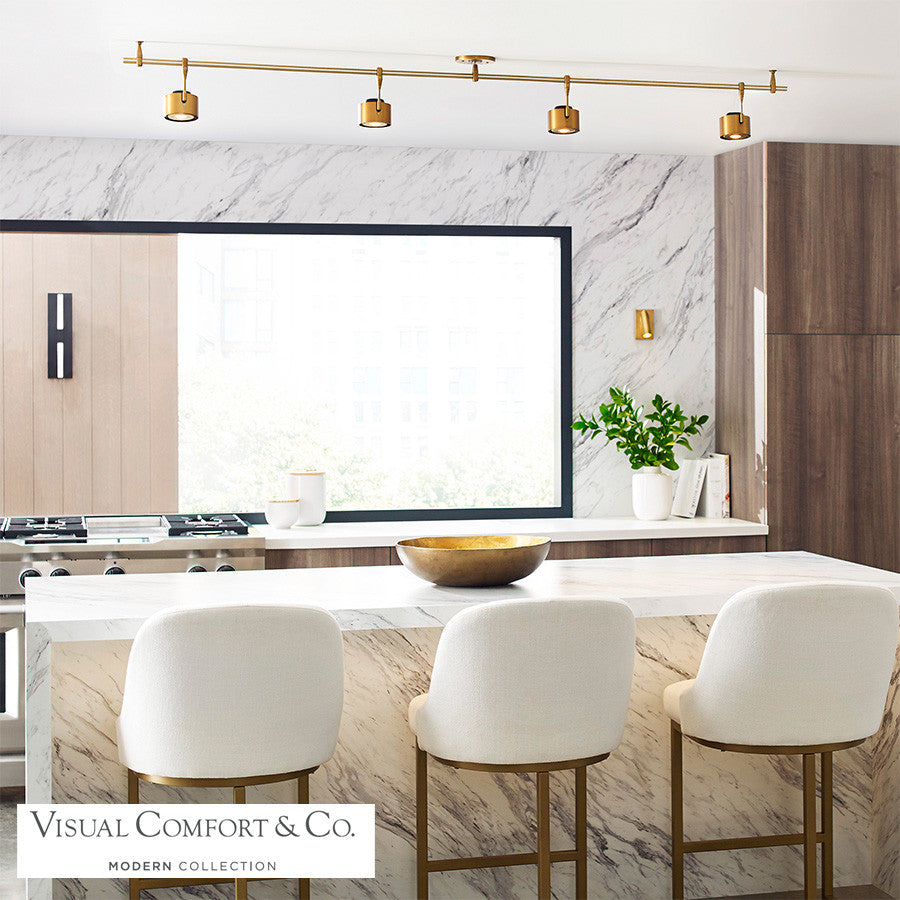 Iso LED Track Head installed above a kitchen island, providing adjustable lighting over a space with three counter stools.