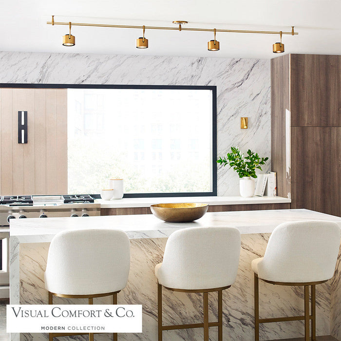 Iso LED Track Head installed above a kitchen island, providing adjustable lighting over a space with three counter stools.