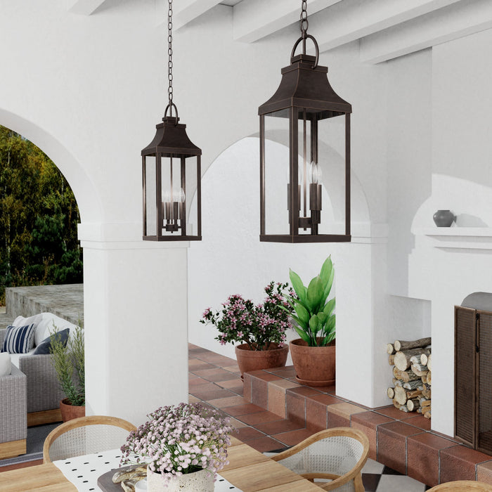 A pair of Bradford Pendants styled over an outdoor patio dining table and chairs.