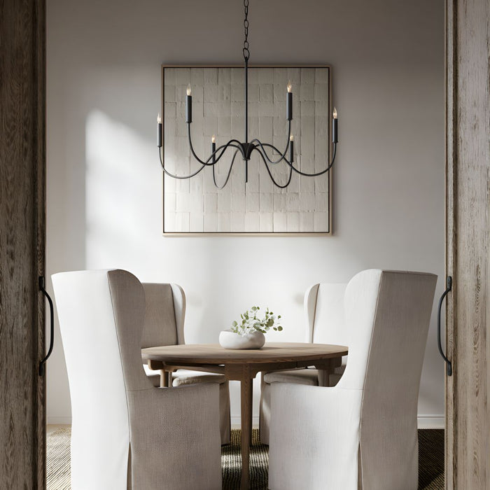 Tirrell Small Black Chandelier centered in a contemporary dining room, suspended above a round brown table surrounded by four transitional dining chairs.