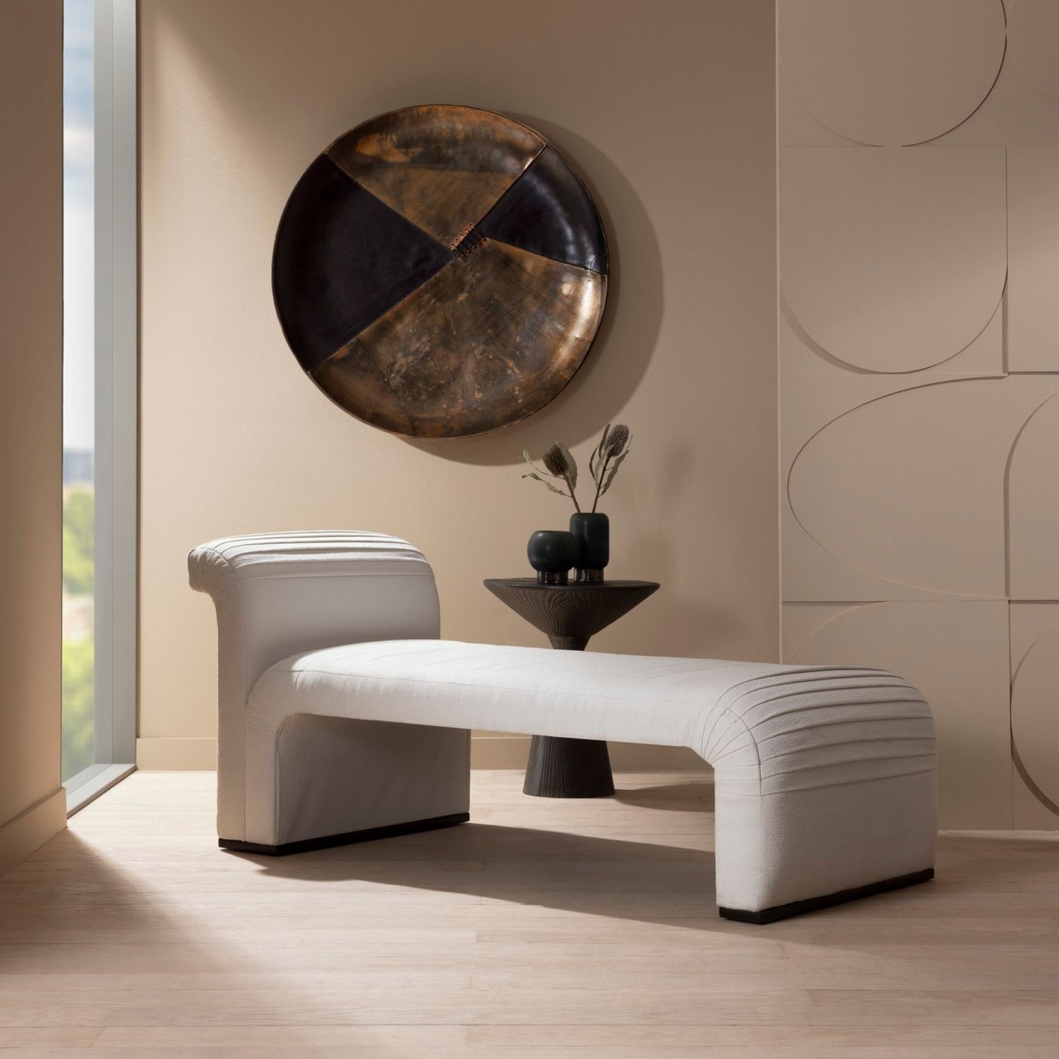 Virgil Wall Plaque displayed on a wall, paired with the Weaver Chaise positioned in front and a side table adorned with vases.