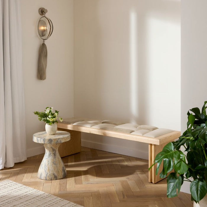 Fairfield Bench styled in an entryway alongside a green plant, set against light wood flooring, with a wall sconce to the left and a side table topped with a plant.
