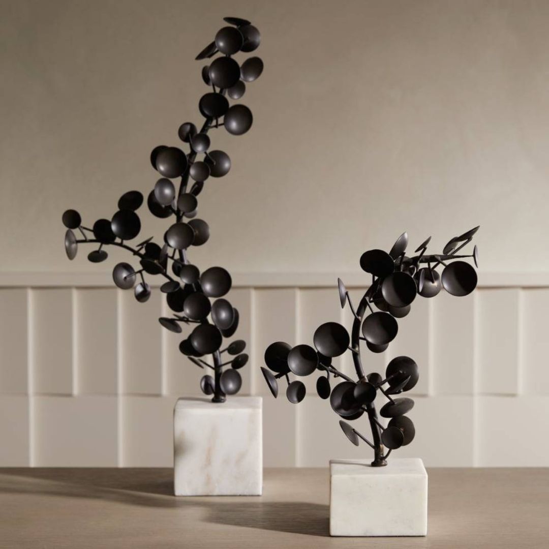 Detail image of the Labyrinth Sculptures, Set of 2, featuring a bronze finish for a vintage aesthetic, each resting on a thick white marble base for a museum-inspired presentation.