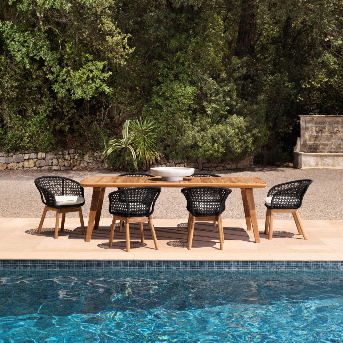 Trinity Outdoor Dining Chair styled poolside alongside the Glover Outdoor Dining Table.