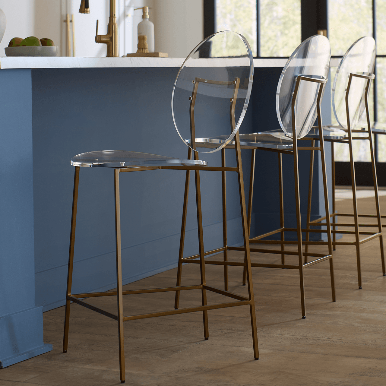 Sandy Counter Stool styled in a kitchen featuring a blue island and wood flooring.