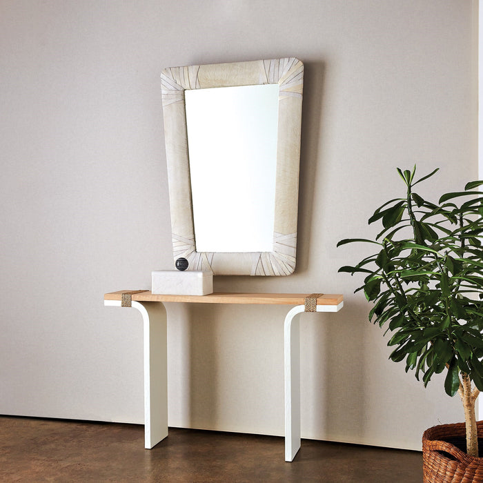 Gabriel Mirror in a white leather finish styled above a modern console table accented with a decorative box.