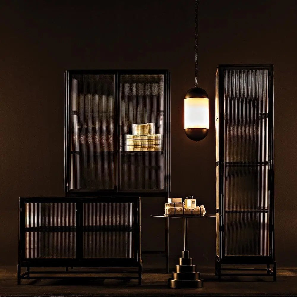 Noir Chandler 2 Door Sideboard Matte Black with fluted glass doors, at left in a dark room with taller matching cabinets and a lit pendant