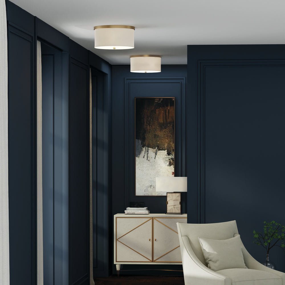 Two Midtown flush mounts styled in a row down a hallway that is painted dark blue leading to a console table at the end.