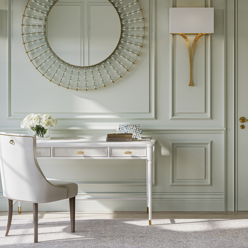 Decorative round mirror with intricate design on a wall above a desk.