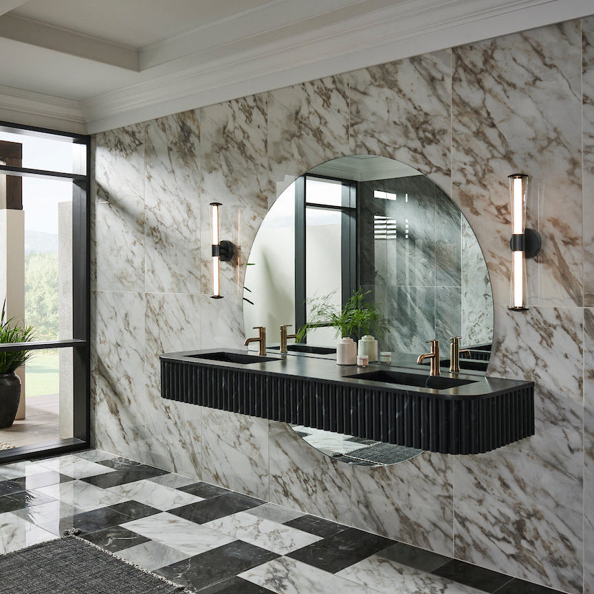 Modern bathroom with marble walls, floating vanity, black countertop, and checkered floor.