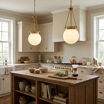 Farmhouse inspired kitchen with wooden island, two globe pendant lights, and various kitchen items.