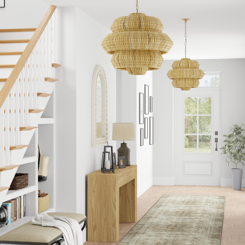 Farmhouse styled interior with wooden console table, staircase, and rattan decorative lights.