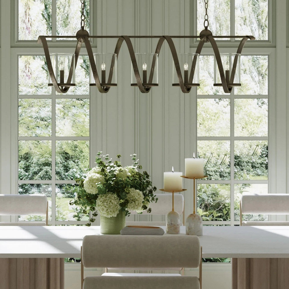 Dining room with a large rustic chandelier, table, chairs, and decorative elements.