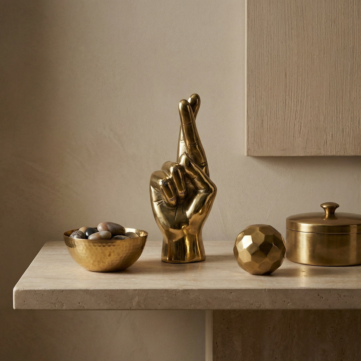Noir Fingers Crossed Sculpture Antique Brass styled in an interior setting