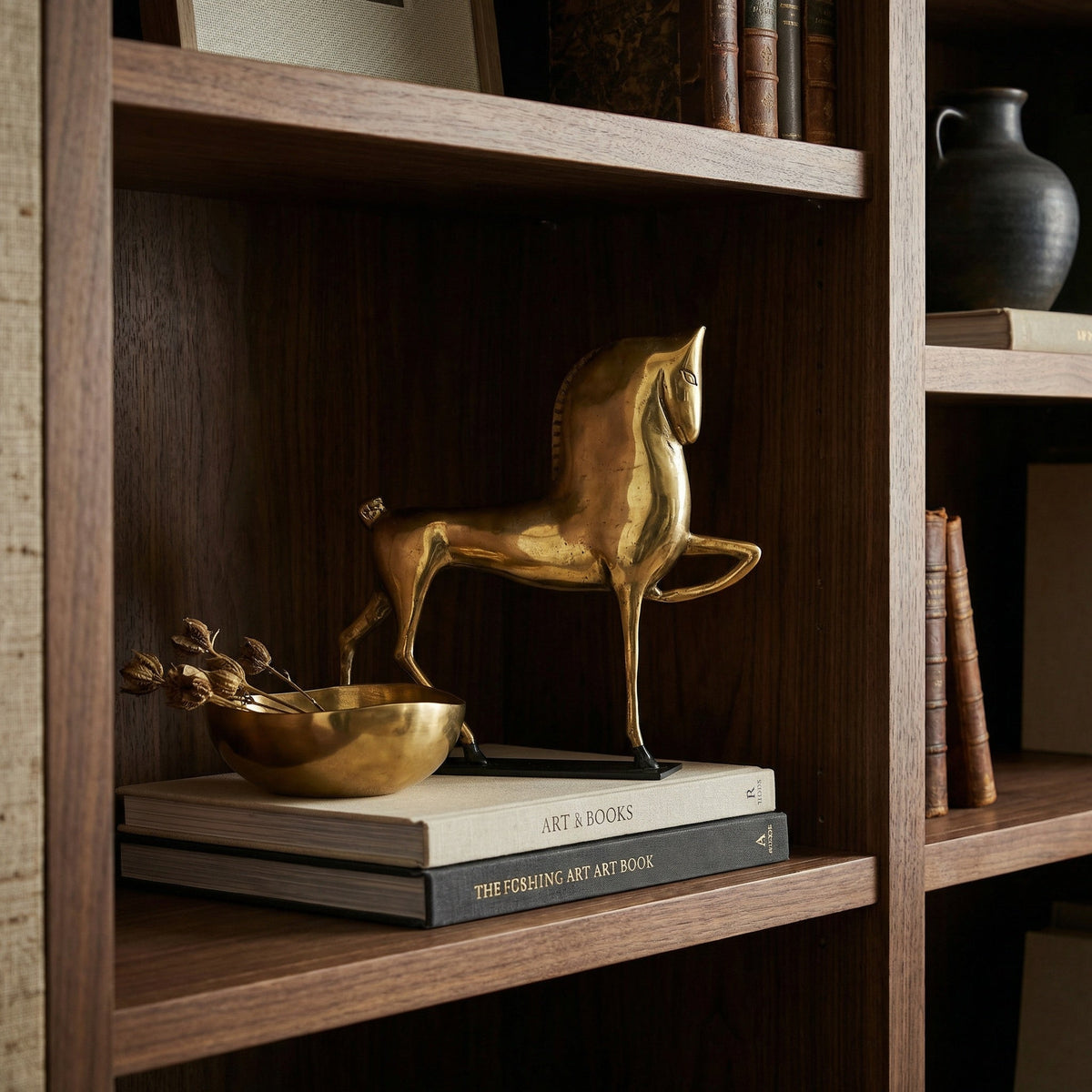 Noir Horse On Stand Sculpture Antique Brass, Matte Black styled in an interior setting