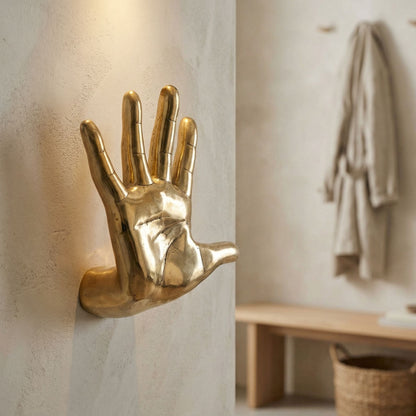 Noir Hand On The Wall Sculpture Antique Brass styled in an interior setting