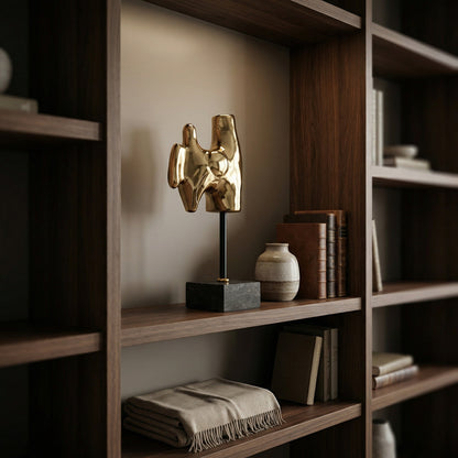 Noir Goker with Stand Sculpture Antique Brass styled in an interior setting