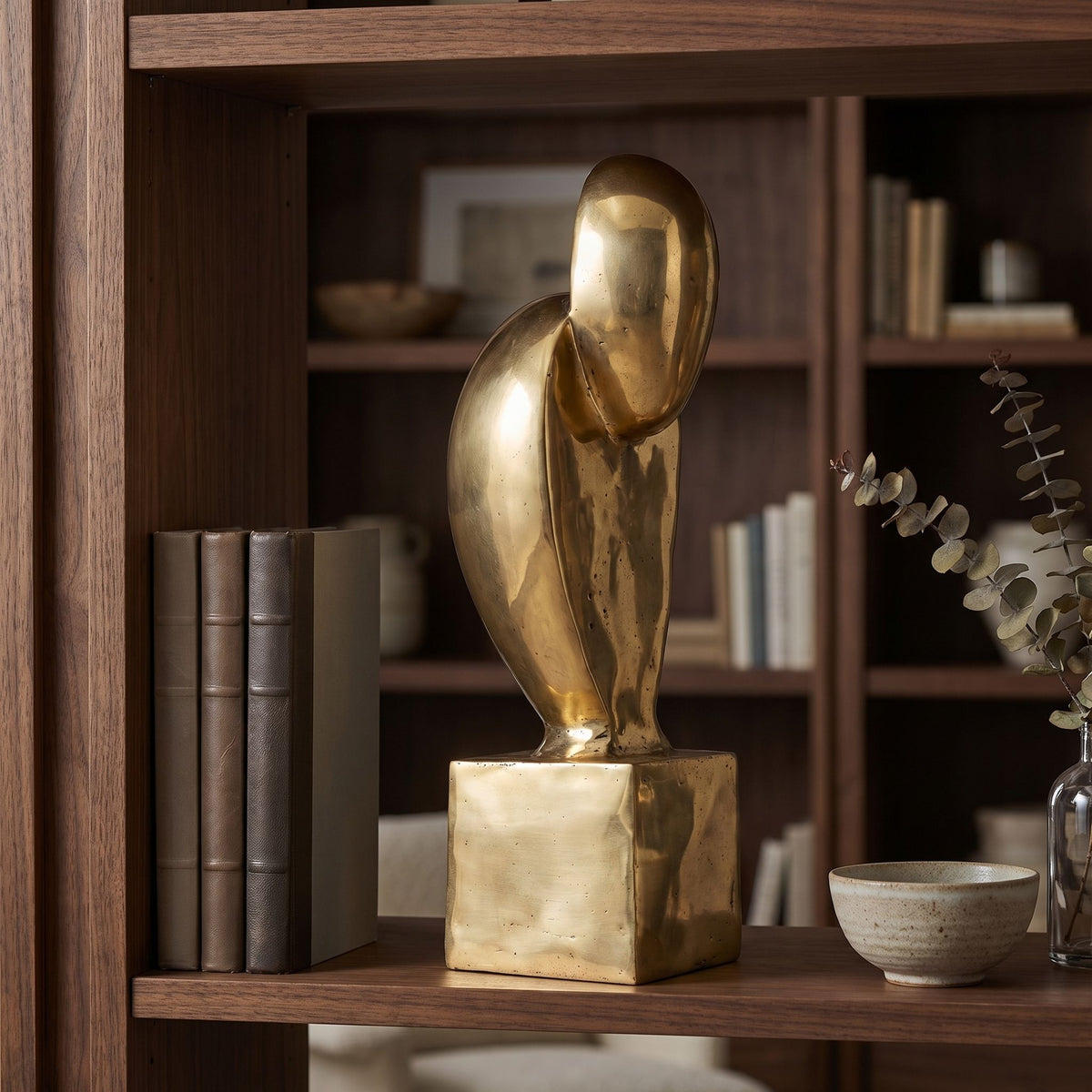 Noir Ripley Sculpture Antique Brass styled in an interior setting