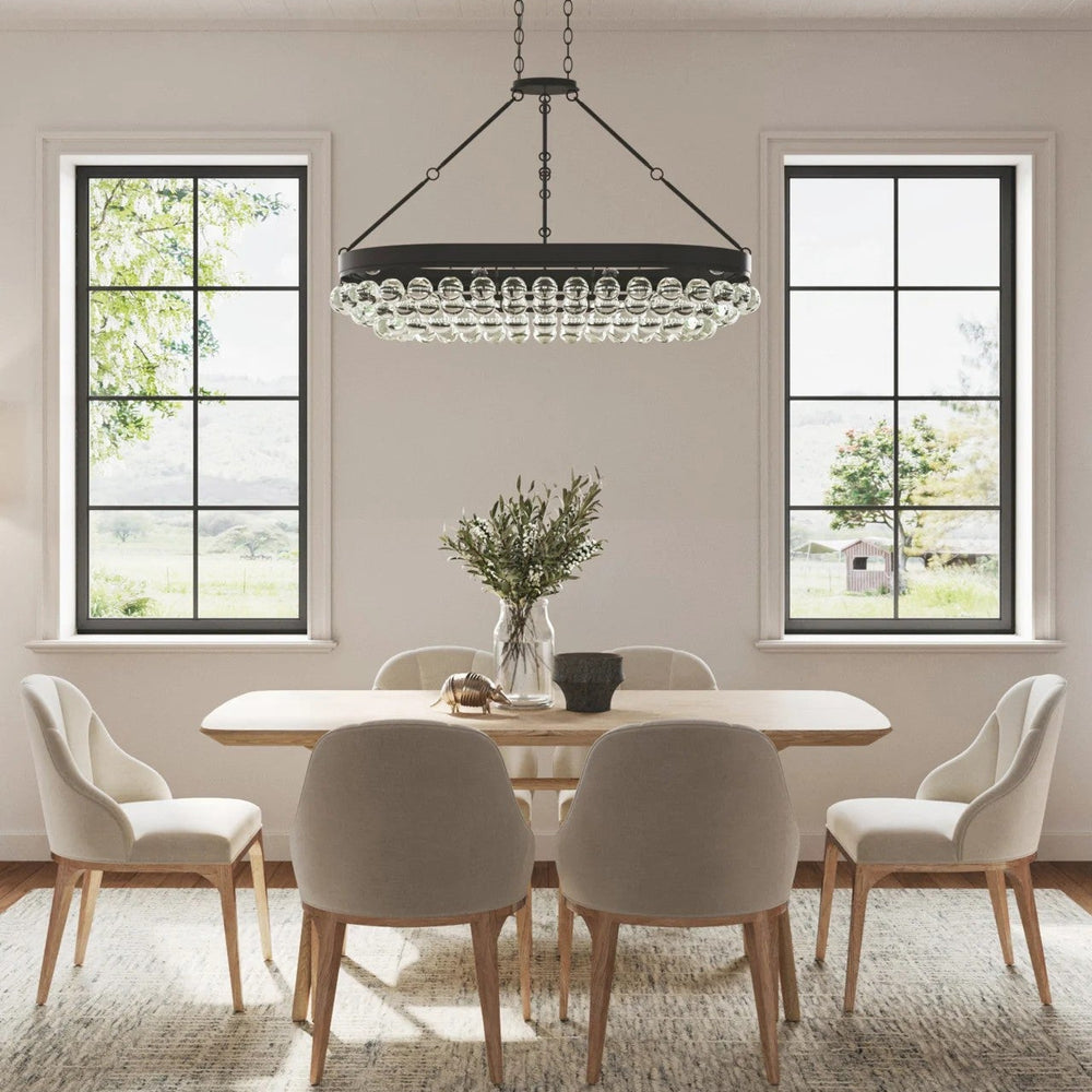 Transitional dining room with a modern chandelier, table, and chairs.