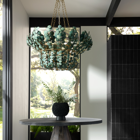 A contemporary entryway with a round wooden table and decorative chandelier.