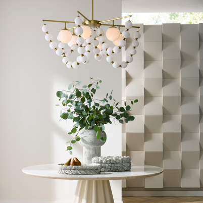 A modern entryway with a round white table, decorative plant, and geometric wall panel.