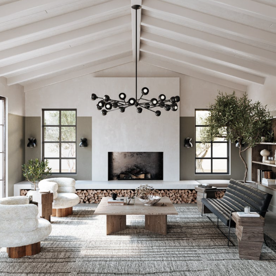 Modern living room with a chandelier, sofa, coffee table, fireplace with wood, and decorative items.