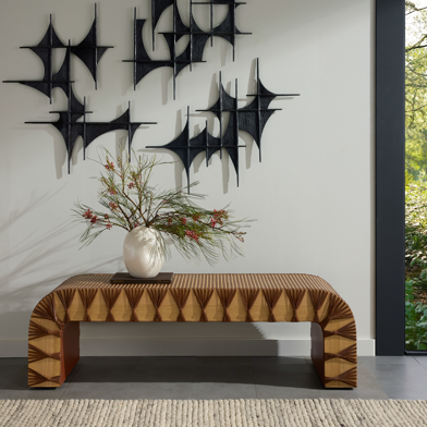 A contemporary entryway with geometric wall art and a patterned bench.