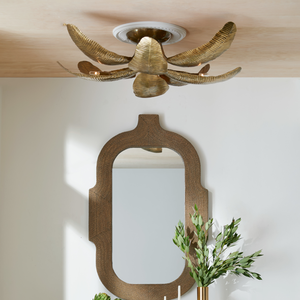 A hallway with a decorative mirror on a white wall with a coastal semi flush mount hanging above.