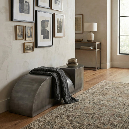 Noir Crafter Bench Gun Metal in an entryway with a charcoal knit throw and a gallery wall of framed art