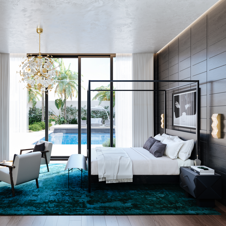 Transitional bedroom with a pool view, featuring a bed, chairs, and decorative elements.