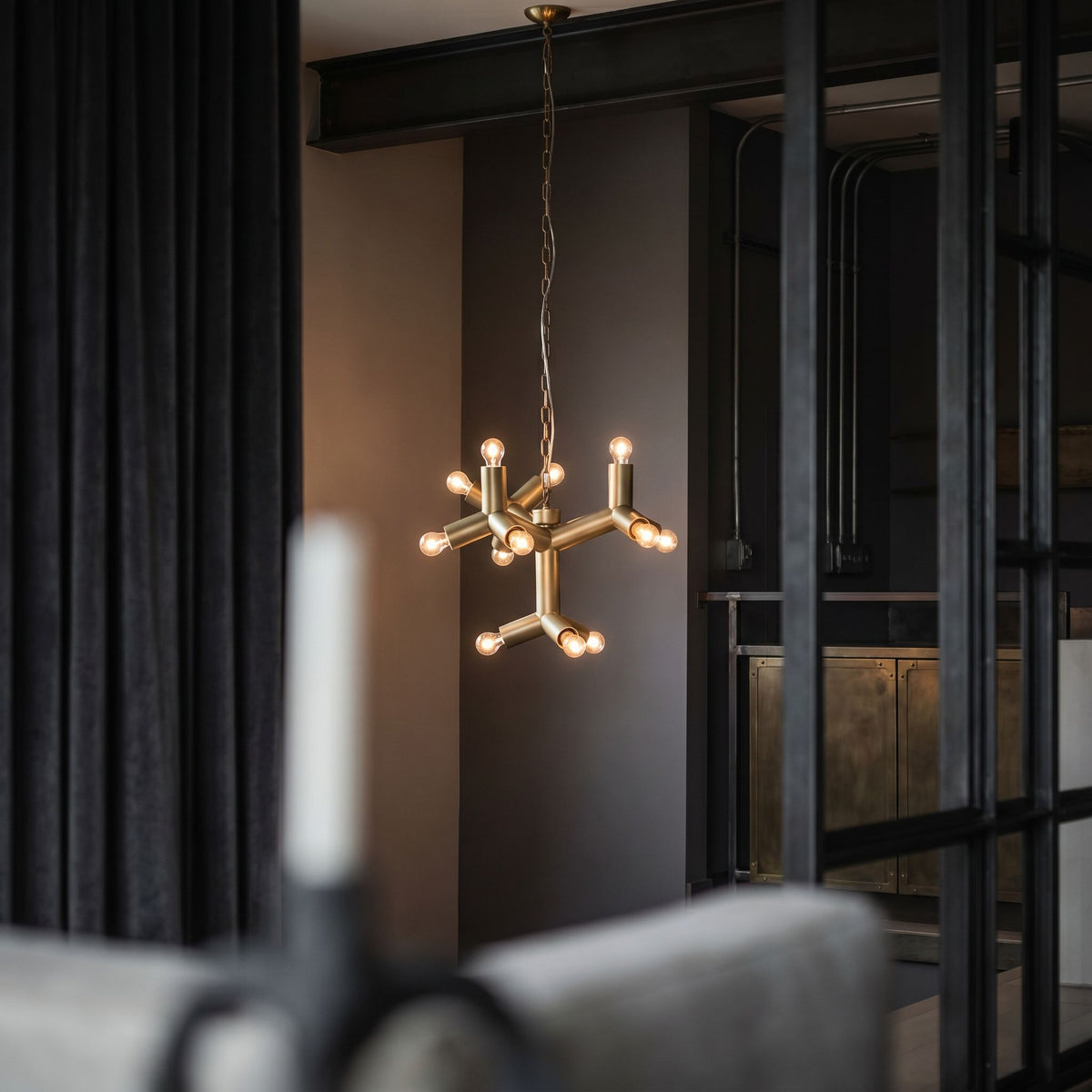 Noir Snow Flake Chandelier Antique Brass styled in an interior setting