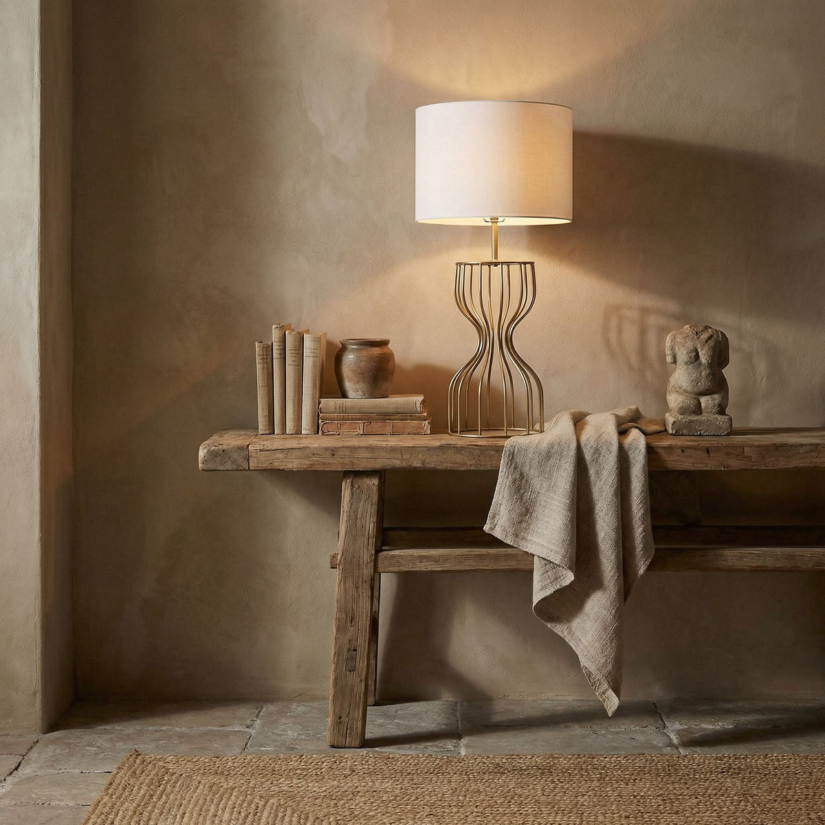 Noir Perry Table Lamp Antique Brass styled in an interior setting