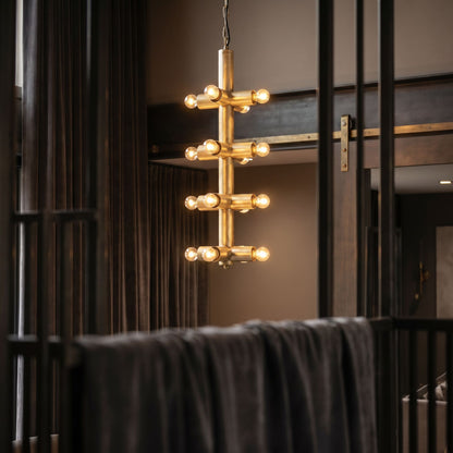 Noir Axe Chandelier Antique Brass styled in an interior setting