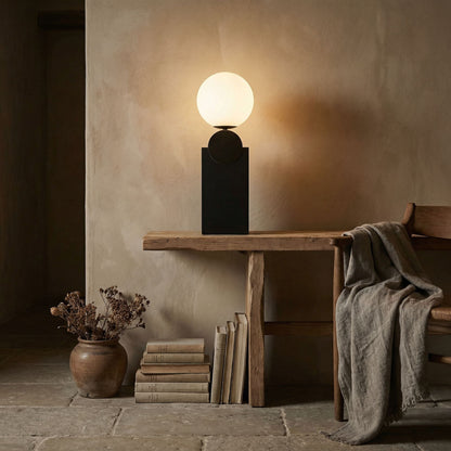 Noir Kate Table Lamp Matte Black, Antique Brass styled in an interior setting