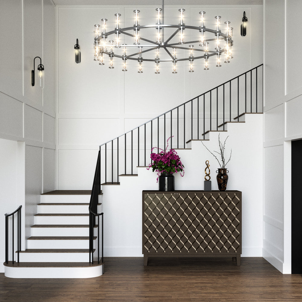 A foyer with a staircase with decorative console table and chandelier in a modern interior setting.