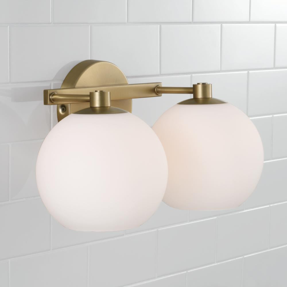 Capital 2-Light Circular Globe Vanity in Aged Brass with Soft White Glass