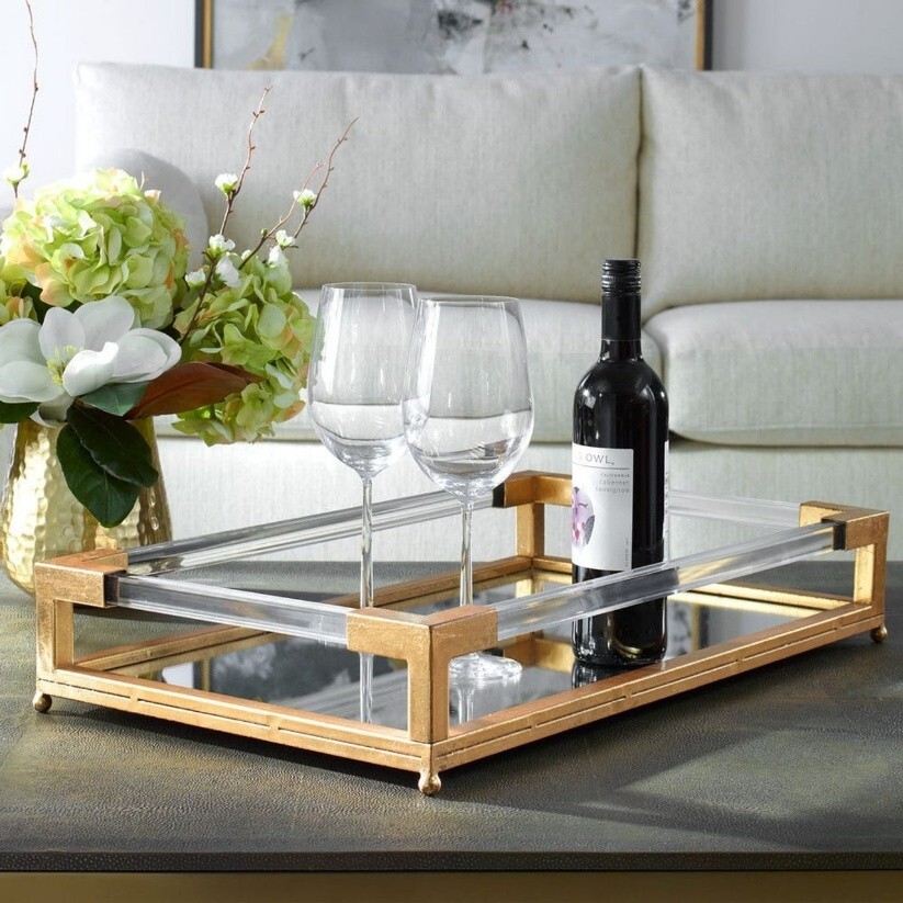 A wine bottle and glasses on a table styled with a tray